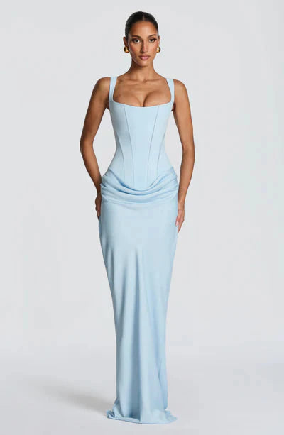 Front view of a light blue Celeste corset maxi dress featuring a structured bodice and elegant draped skirt.