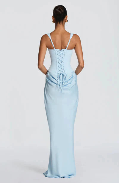 Back view of a light blue Celeste corset maxi dress with adjustable straps and a detailed lace-up back.