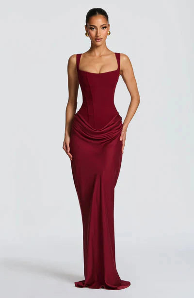 Front view of a rich burgundy Celeste corset maxi dress with a square neckline and draped waist detail.