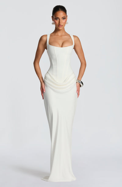 Full-length front view of the ivory Celeste Corset Maxi Dress, showcasing the elegant silhouette and draped skirt.