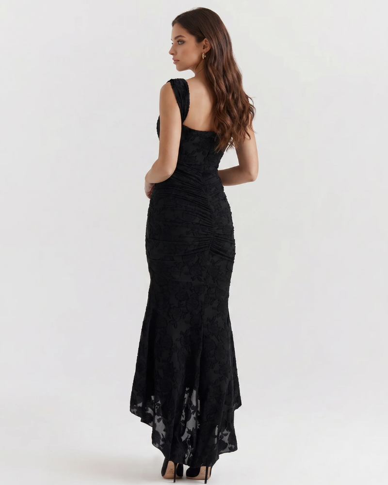 Back view black corset midi dress with ruched center seam, wide straps and high-low skirt