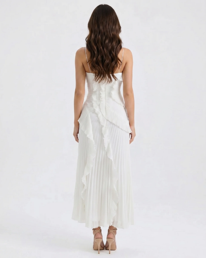 Back view of white ruffle maxi dress showing slim straps, fitted bodice and pleated skirt