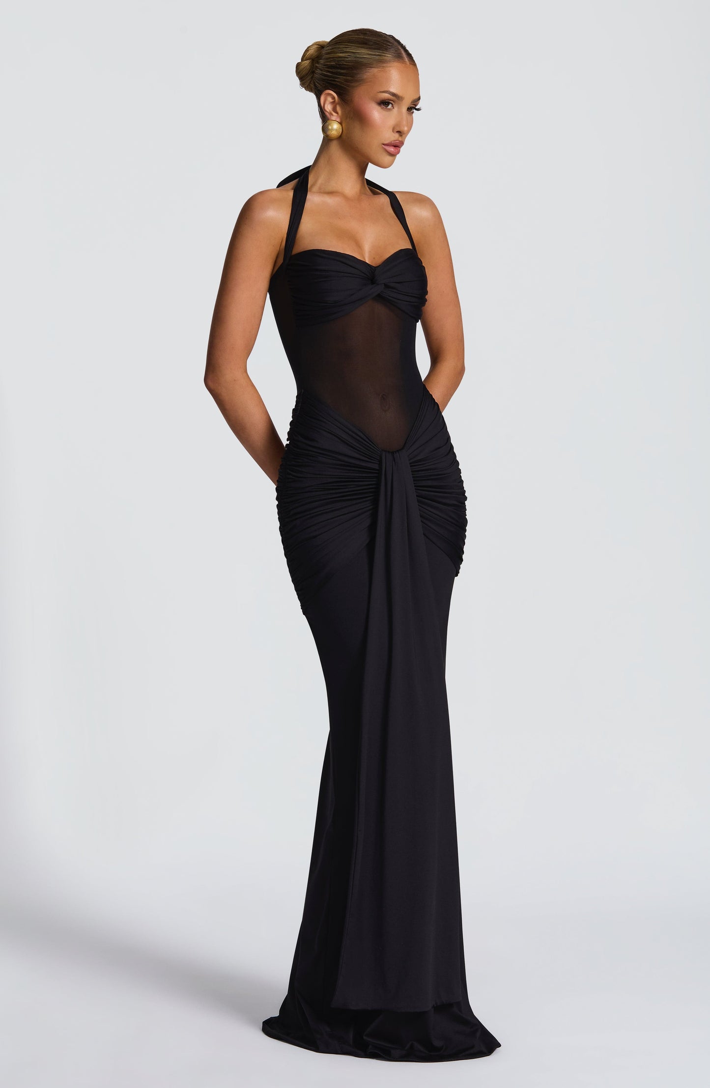 Stylish black Jayleen Ruched Maxi Dress with a sheer midsection and intricate ruching on the skirt.