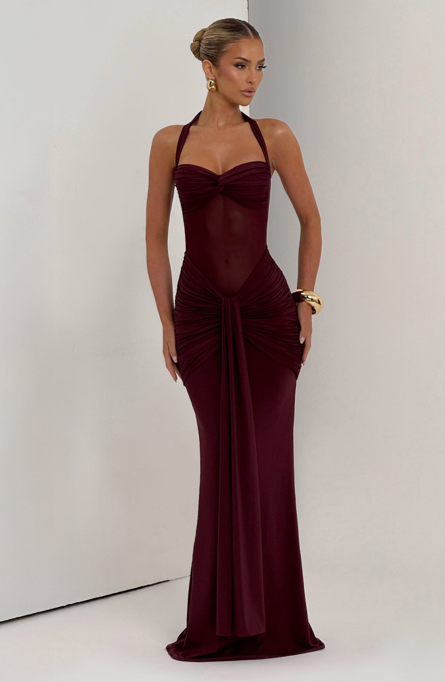 Burgundy Jayleen Ruched Maxi Dress featuring a sheer bodice, halter neck, and gathered skirt details.