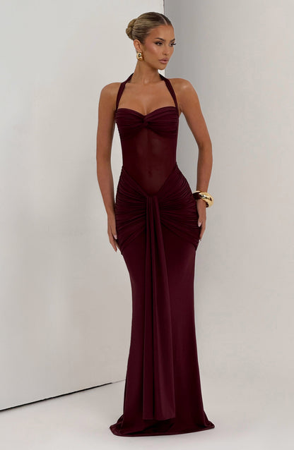 Burgundy Jayleen Ruched Maxi Dress featuring a sheer bodice, halter neck, and gathered skirt details.