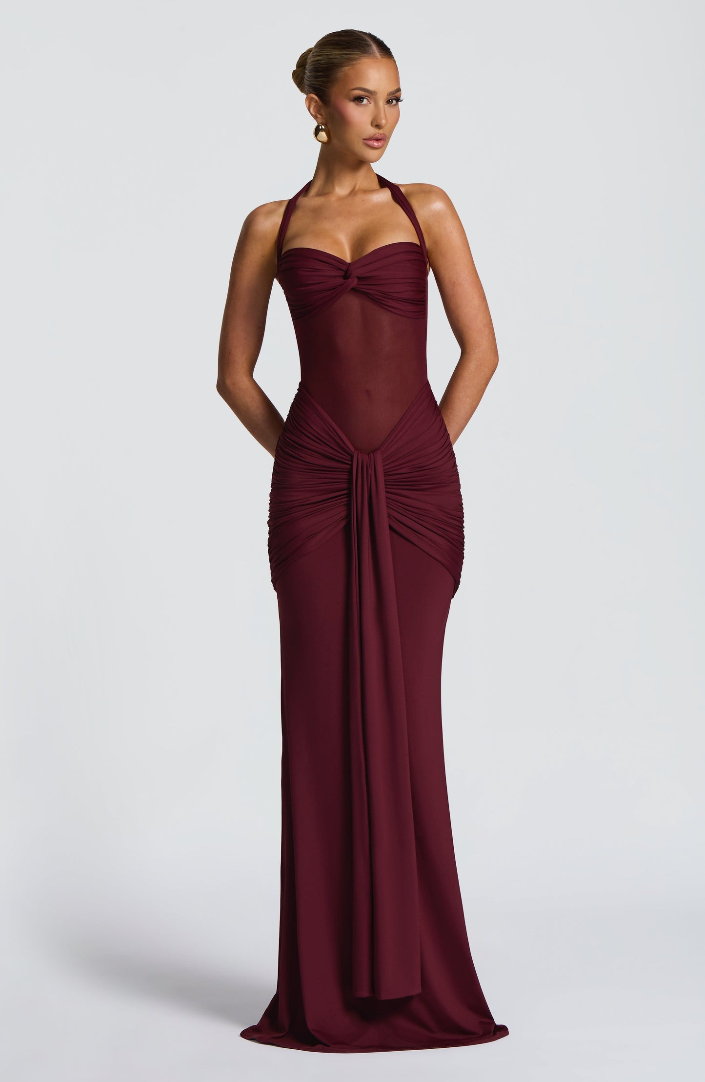Front view of a dark red Jayleen Ruched Maxi Dress, showcasing the ruched waist and flowing skirt.