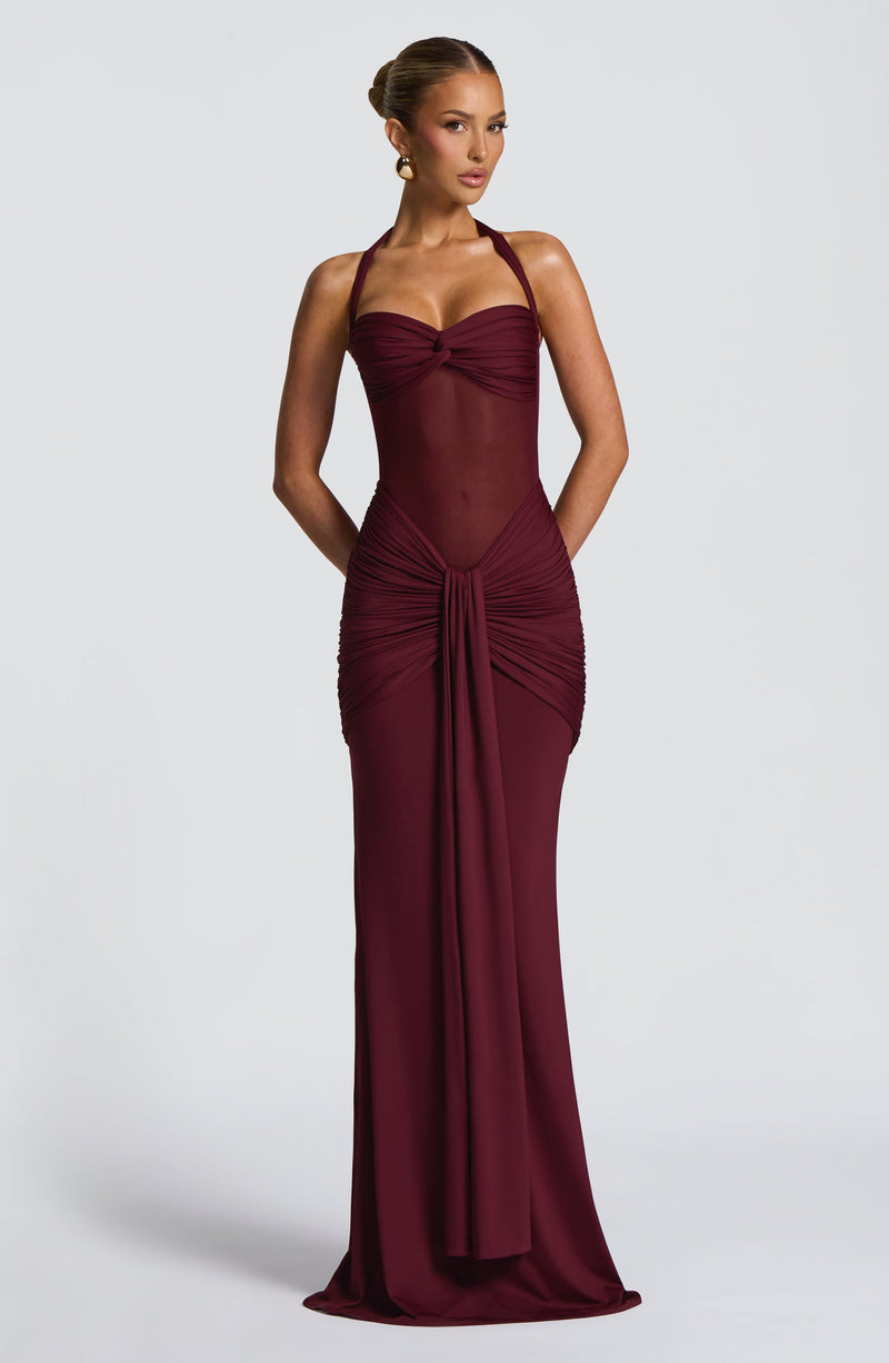 Front view of a dark red Jayleen Ruched Maxi Dress, showcasing the ruched waist and flowing skirt.