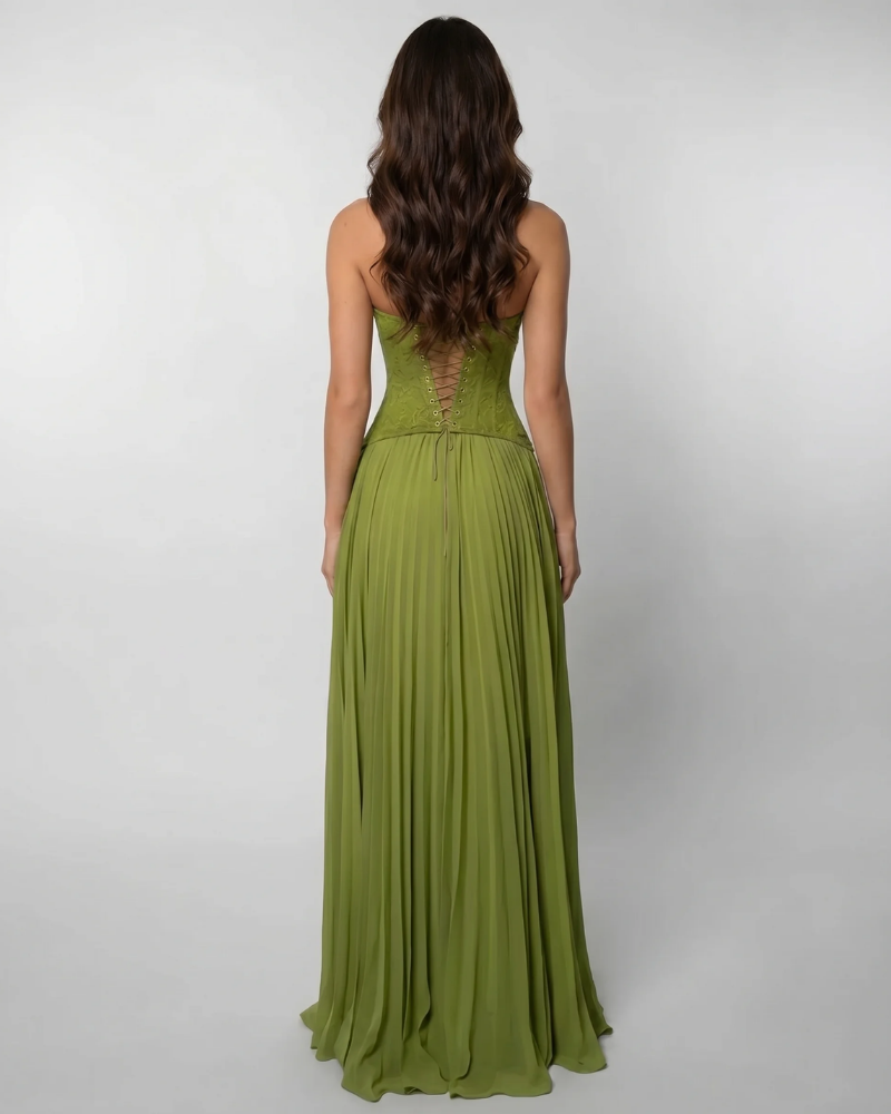 Back view of green corset maxi dress with lace-up bodice and pleated skirt falling to the floor