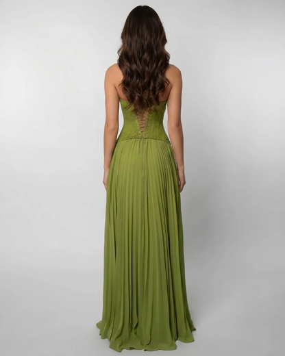 Back view of green corset maxi dress with lace-up bodice and pleated skirt falling to the floor