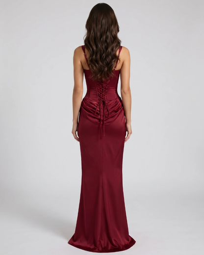 Back view of burgundy maxi dress with lace-up corset back and floor-length satin skirt