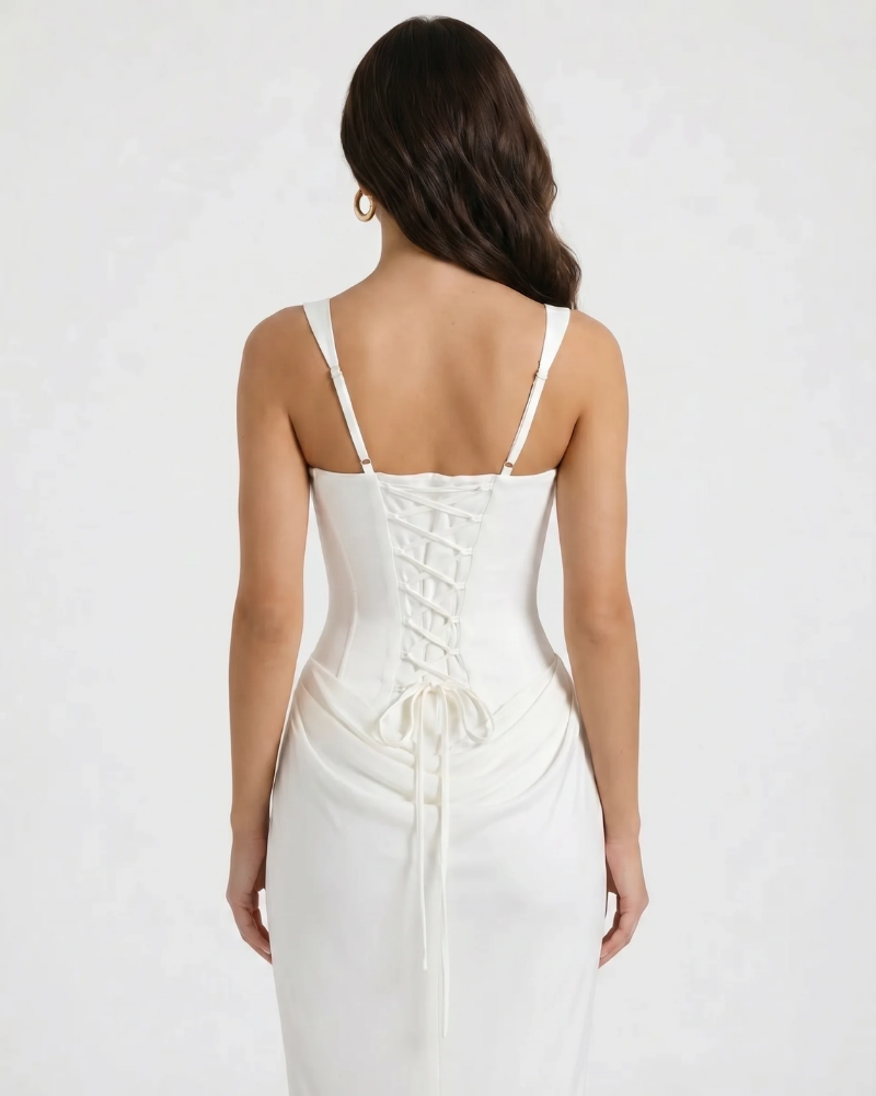 Close-up back of white maxi dress highlighting lace-up corset panel and ruched detail at lower back