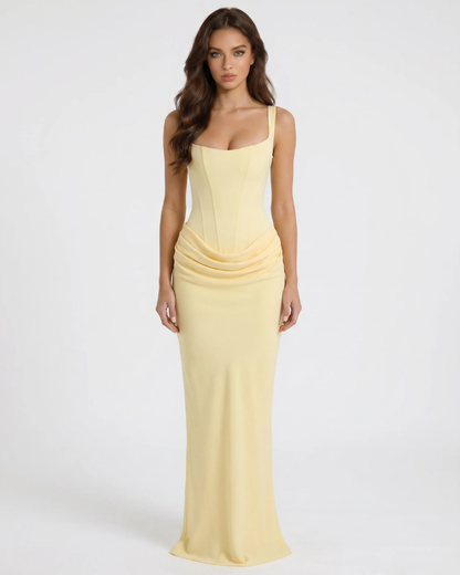 Yellow draped maxi dress with square neckline, corset-style seams, and fitted skirt