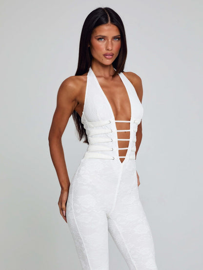 Front view of a white Kenzie Halter Jumpsuit, showcasing a deep V-neck and white strap detailing on the bodice.