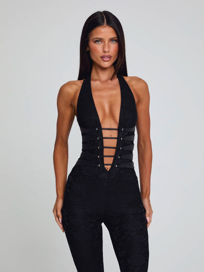 Black Kenzie halter jumpsuit with a deep V-neck, prominent corset-style lacing, and an all-over floral lace texture.