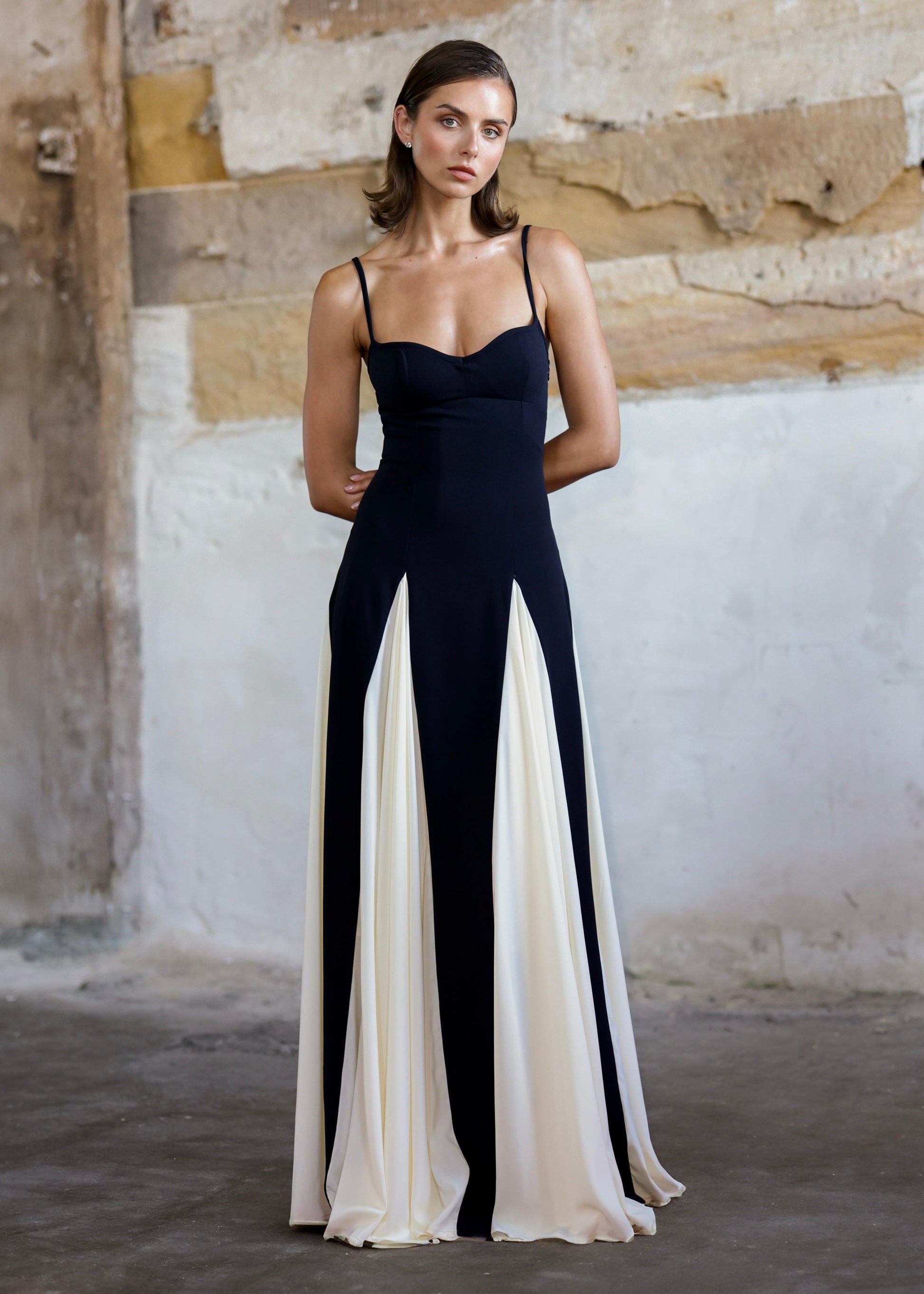 Front view of a black and white paneled maxi dress with a sweetheart neckline and thin straps.