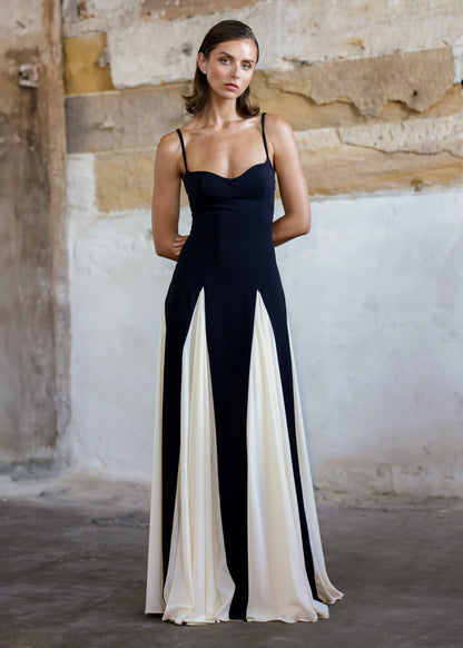 Front view of a black and white paneled maxi dress with a sweetheart neckline and thin straps.