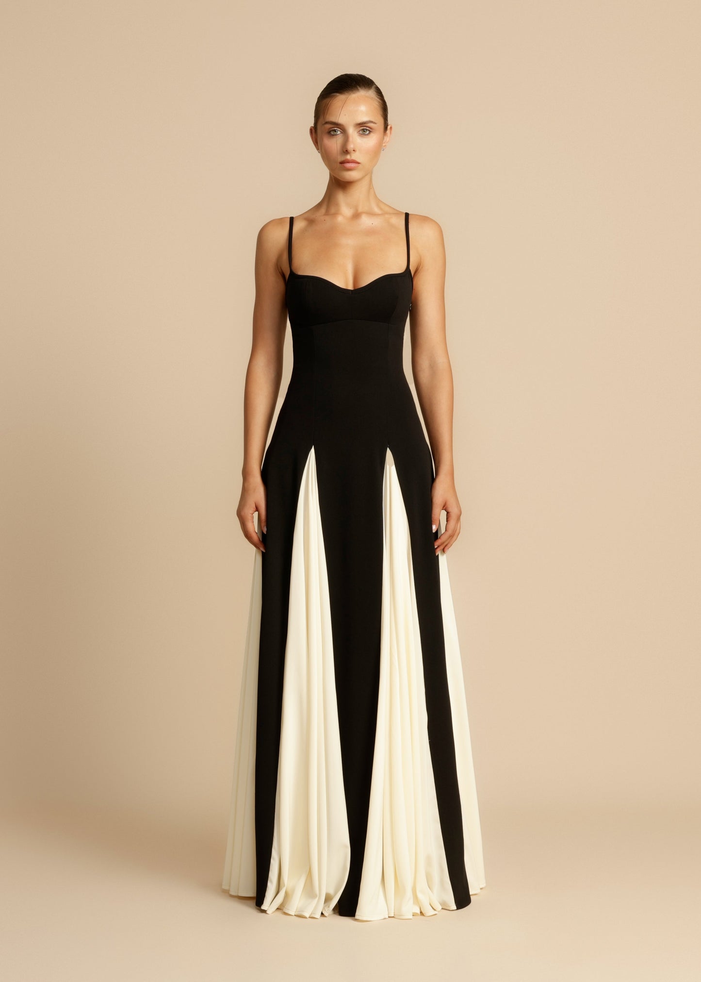 Full length view of a black and white paneled maxi dress with spaghetti straps and sweetheart neckline.