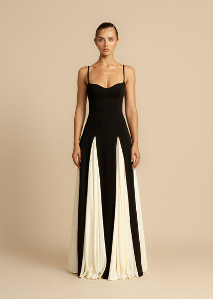 Full length view of a black and white paneled maxi dress with spaghetti straps and sweetheart neckline.