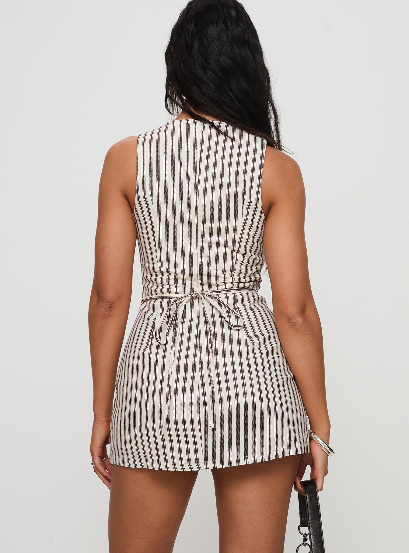 Back view of a sleeveless Lauren striped mini dress with brown vertical stripes and a cinched tie-back.