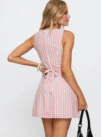 Back view of a sleeveless Lauren striped mini dress with red vertical stripes and a tied bow at the waist.