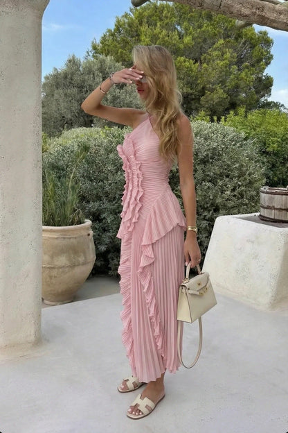 Full body shot of a woman in the pink Millie Ruffle Midi Dress, showcasing the pleated design and ruffled accents.
