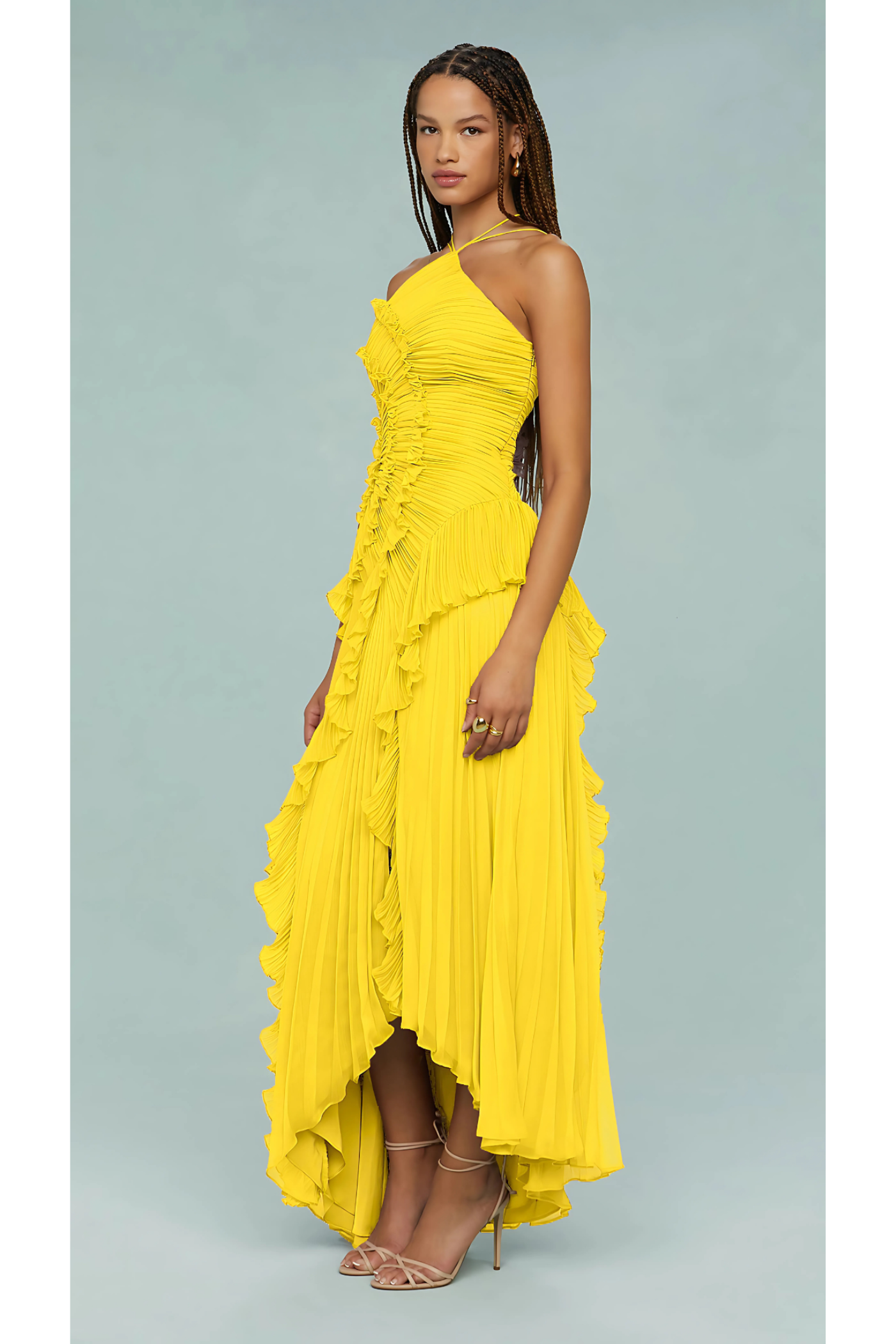 Side profile of a woman wearing a bright yellow Millie Ruffle Midi Dress, highlighting the layered ruffles and high-low hem.