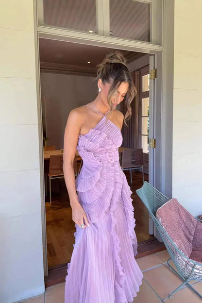 Close-up of the light purple Millie Ruffle Midi Dress, highlighting the layered ruffles and pleated fabric, worn by a woman looking down.