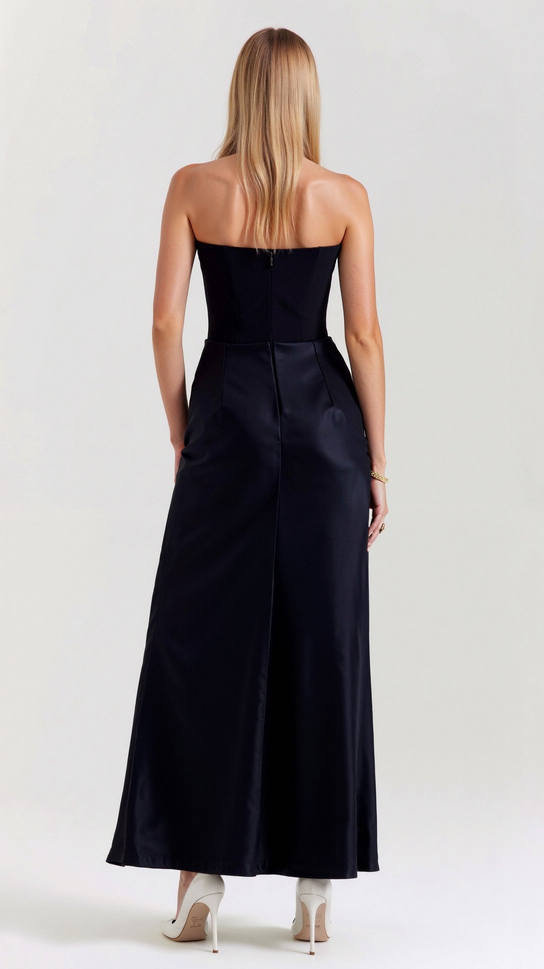 Rear view of the black Samira Draped Maxi Dress, showing the elegant back design and the long, flowing skirt with a slight train.