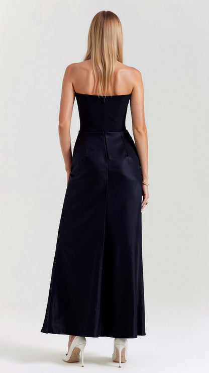 Rear view of the black Samira Draped Maxi Dress, showing the elegant back design and the long, flowing skirt with a slight train.