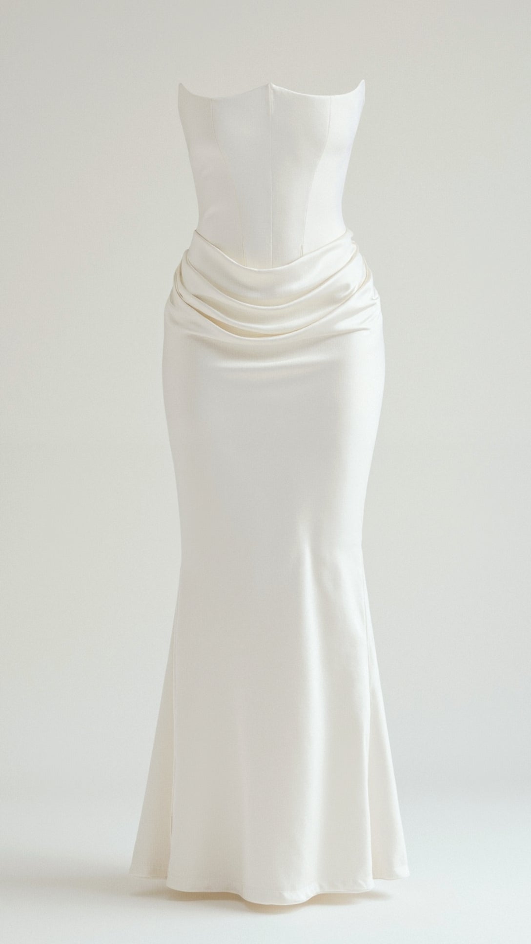 Elegant white strapless maxi dress with a structured bodice and draped waist detail, flowing into a slim skirt.