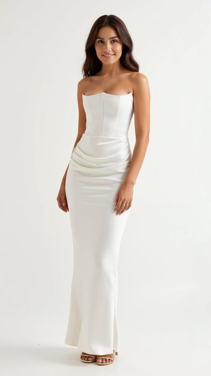 Crisp white Samira Draped Maxi Dress, strapless with a structured top and a subtle draped waist, creating an elegant silhouette.